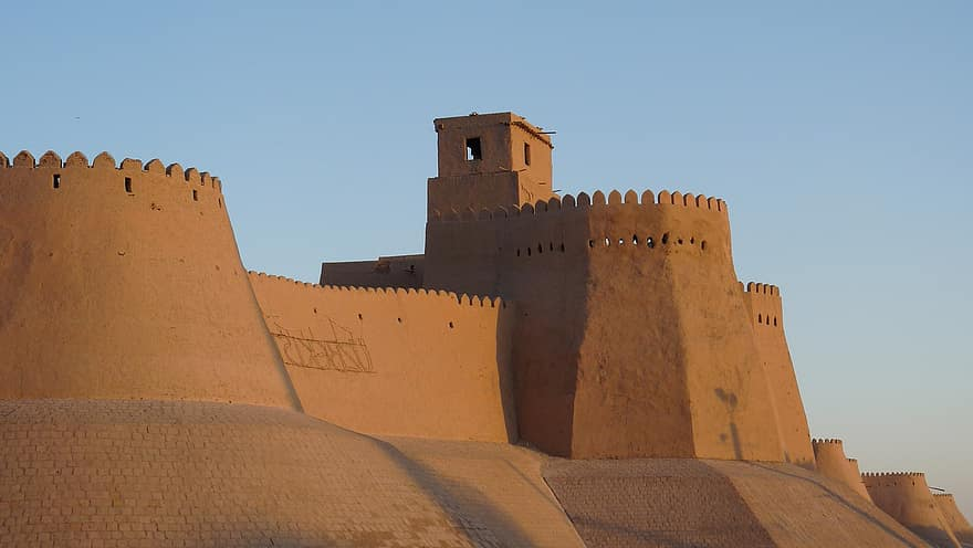 Looking from the outside at a fortress built out of sand coloured rock
