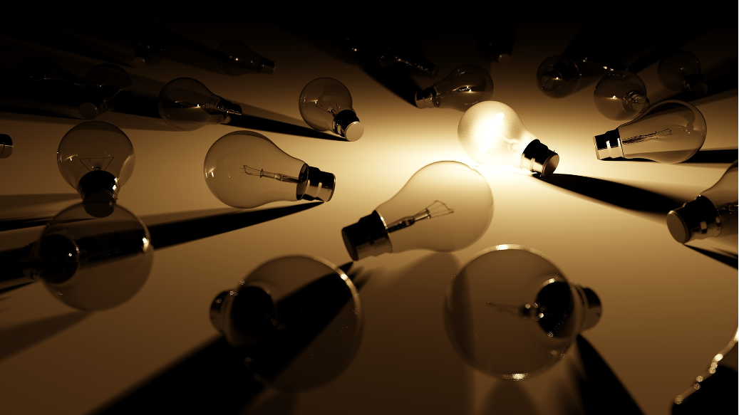 Many lightbulbs gathered together. One is on and is casting shadows over the others.