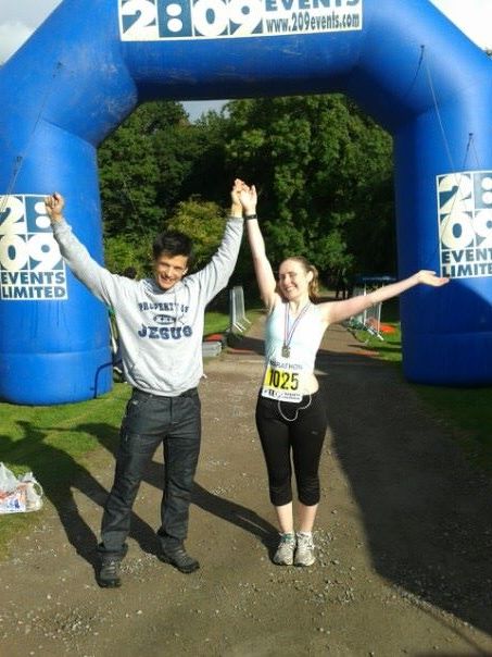 A photo of a male and a female at the finish line of a race