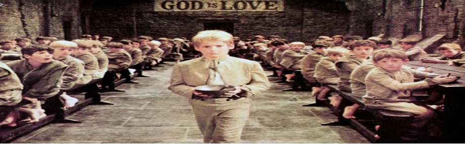 A still from the Oliver Twist film showing Oliver holding his bowl