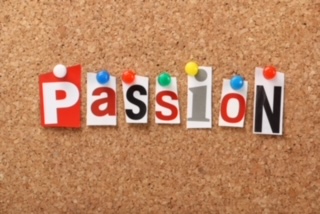 A cork board with cut out words pinned to it, reading 'passion'.