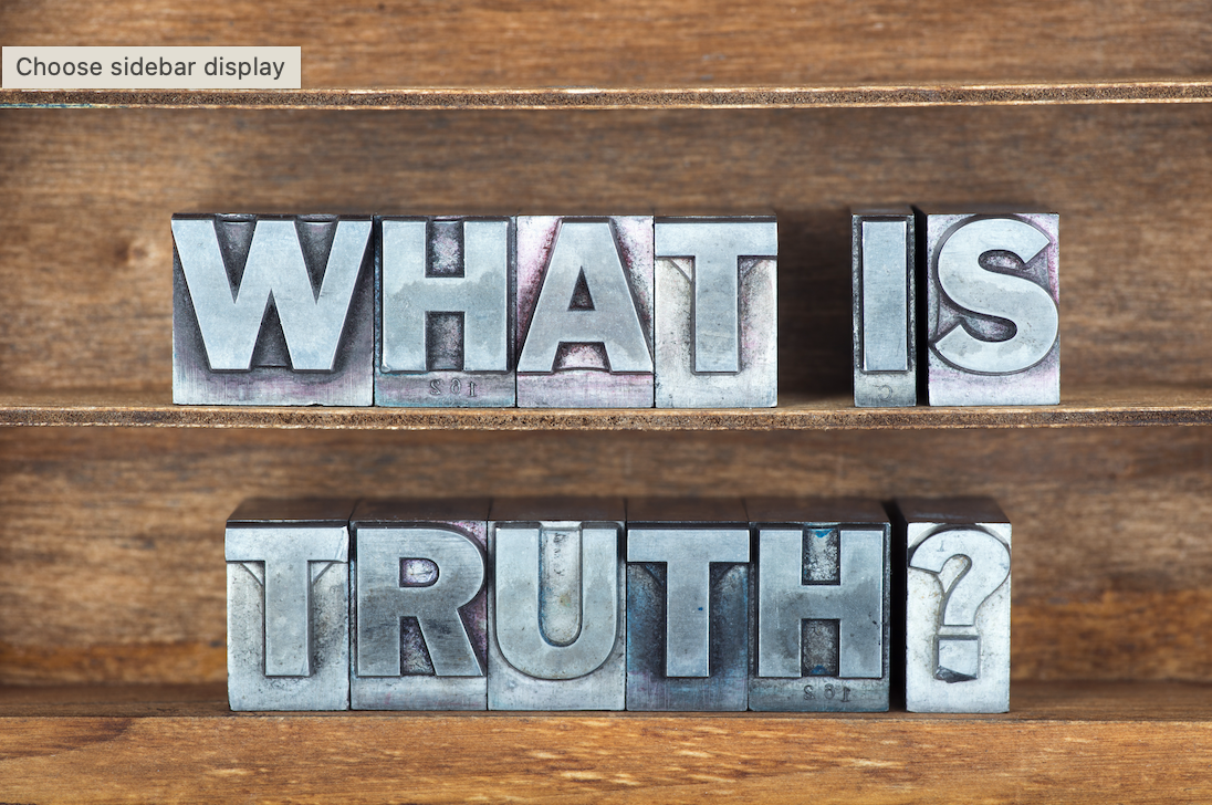 Wooden background with 'What is truth' spelt out in metal lettering
